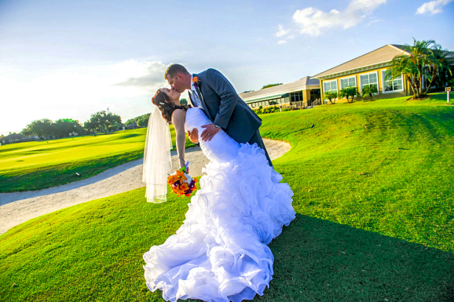 groom kissing bride on the course
